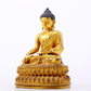 A serene gilt bronze statue of Gautama Buddha