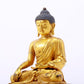 A serene gilt bronze statue of Gautama Buddha