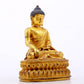 A serene gilt bronze statue of Gautama Buddha