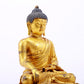 A serene gilt bronze statue of Gautama Buddha