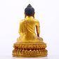 A serene gilt bronze statue of Gautama Buddha