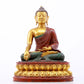 A serene gilt bronze statue of Gautama Buddha