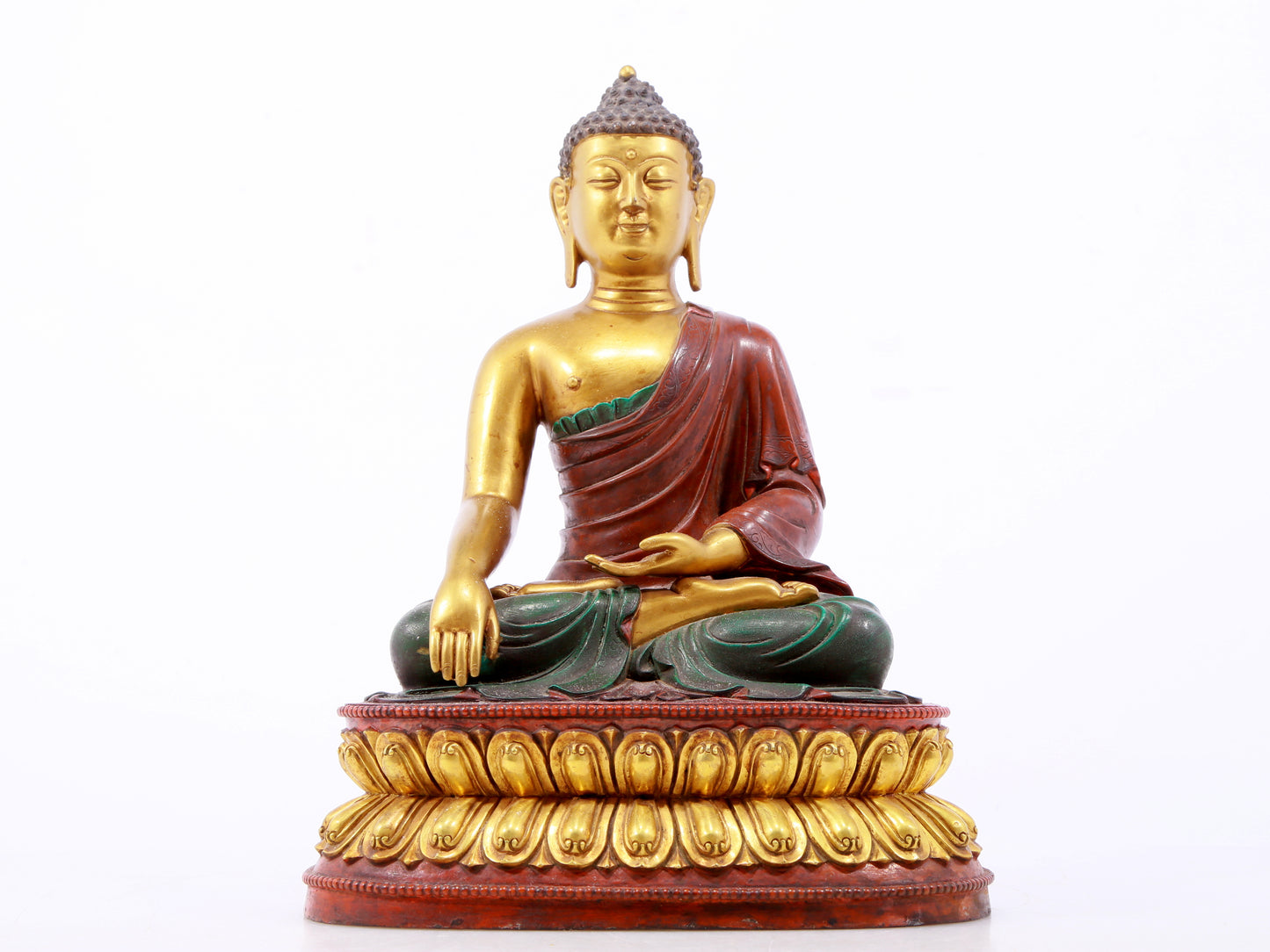 A serene gilt bronze statue of Gautama Buddha