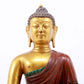 A serene gilt bronze statue of Gautama Buddha