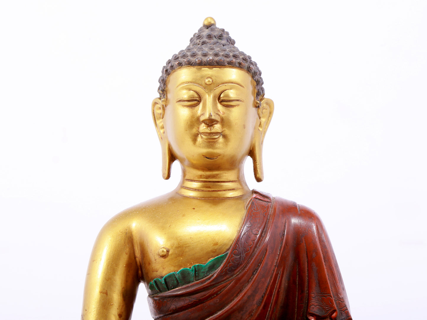 A serene gilt bronze statue of Gautama Buddha