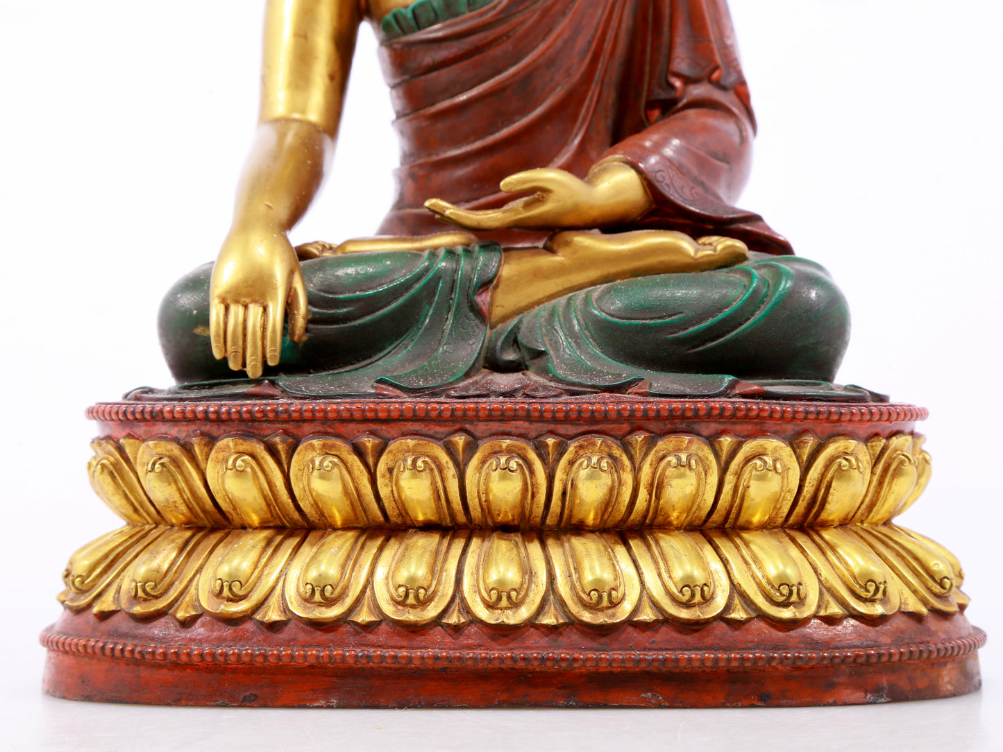 A serene gilt bronze statue of Gautama Buddha