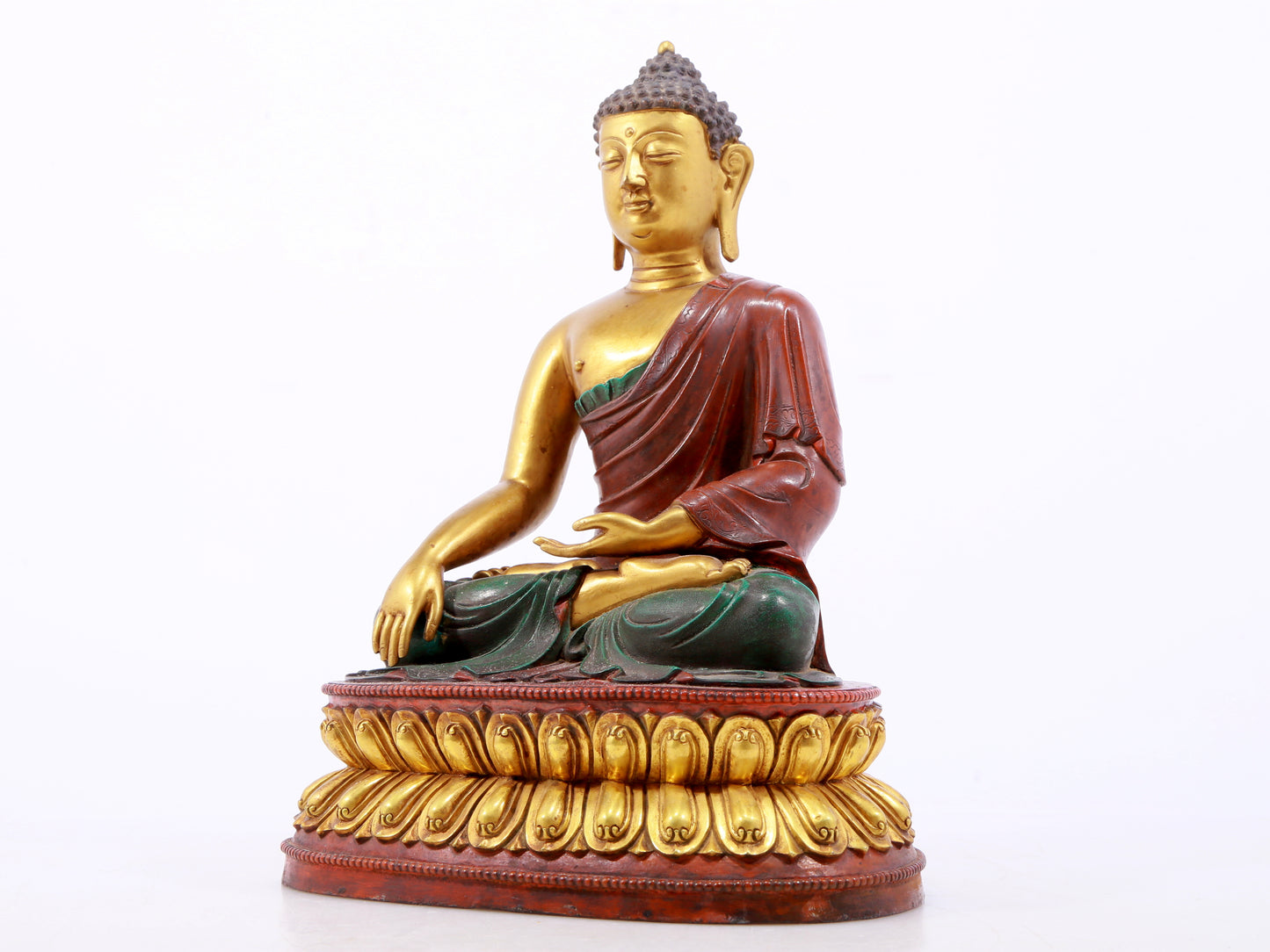 A serene gilt bronze statue of Gautama Buddha