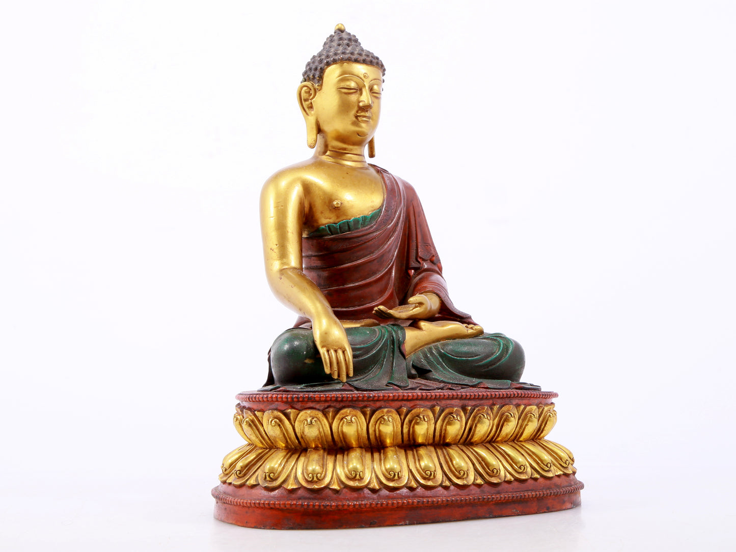 A serene gilt bronze statue of Gautama Buddha