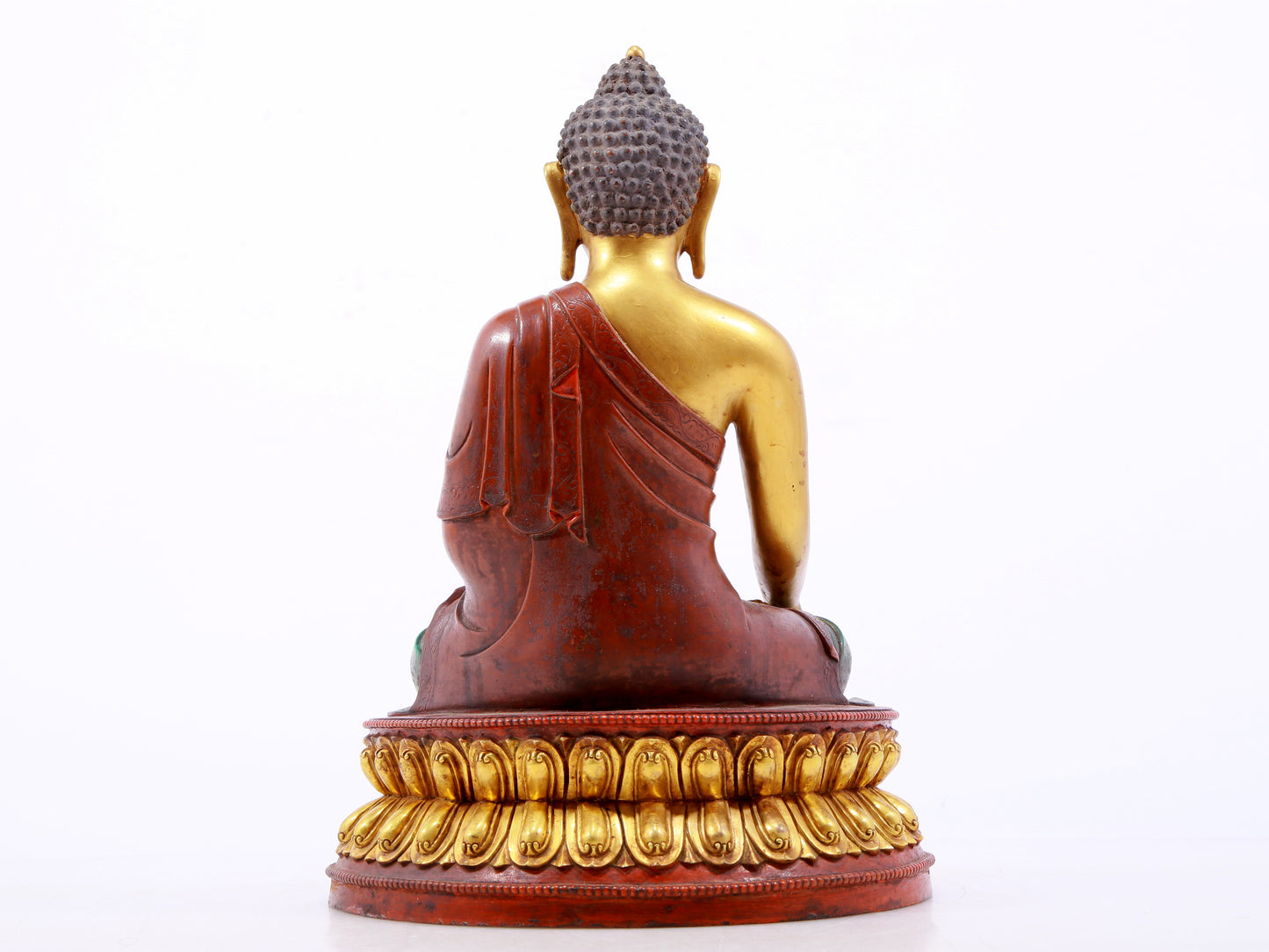 A serene gilt bronze statue of Gautama Buddha