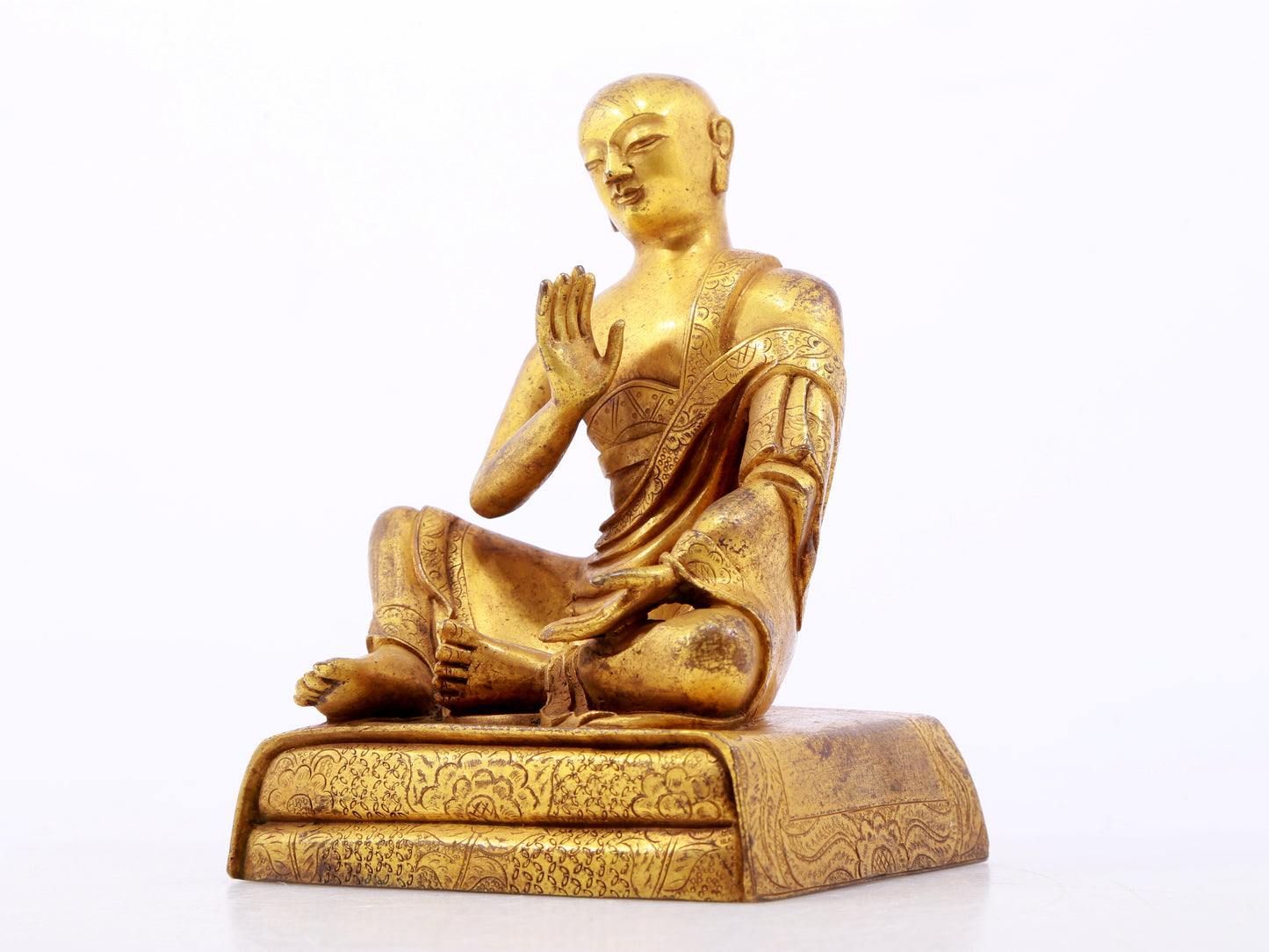 A serene gilt bronze Arhat statue,