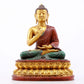 A serene gilt bronze statue of Gautama Buddha