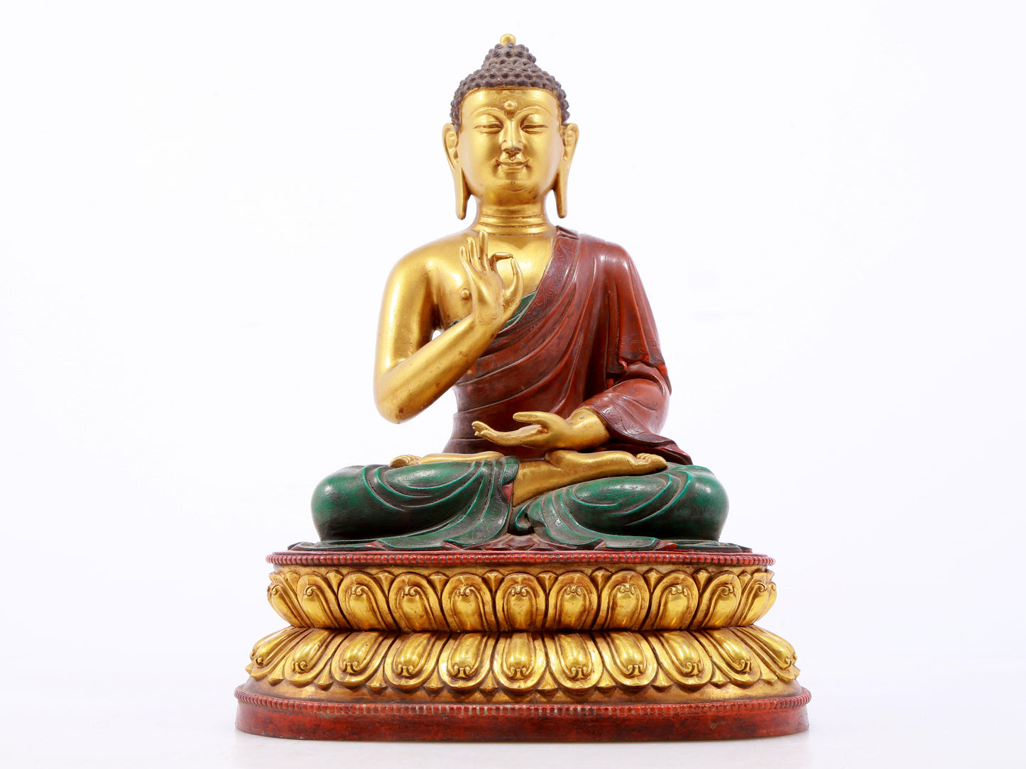 A serene gilt bronze statue of Gautama Buddha