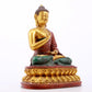 A serene gilt bronze statue of Gautama Buddha