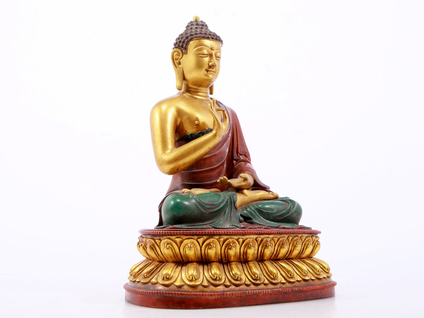 A serene gilt bronze statue of Gautama Buddha