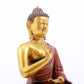 A serene gilt bronze statue of Gautama Buddha