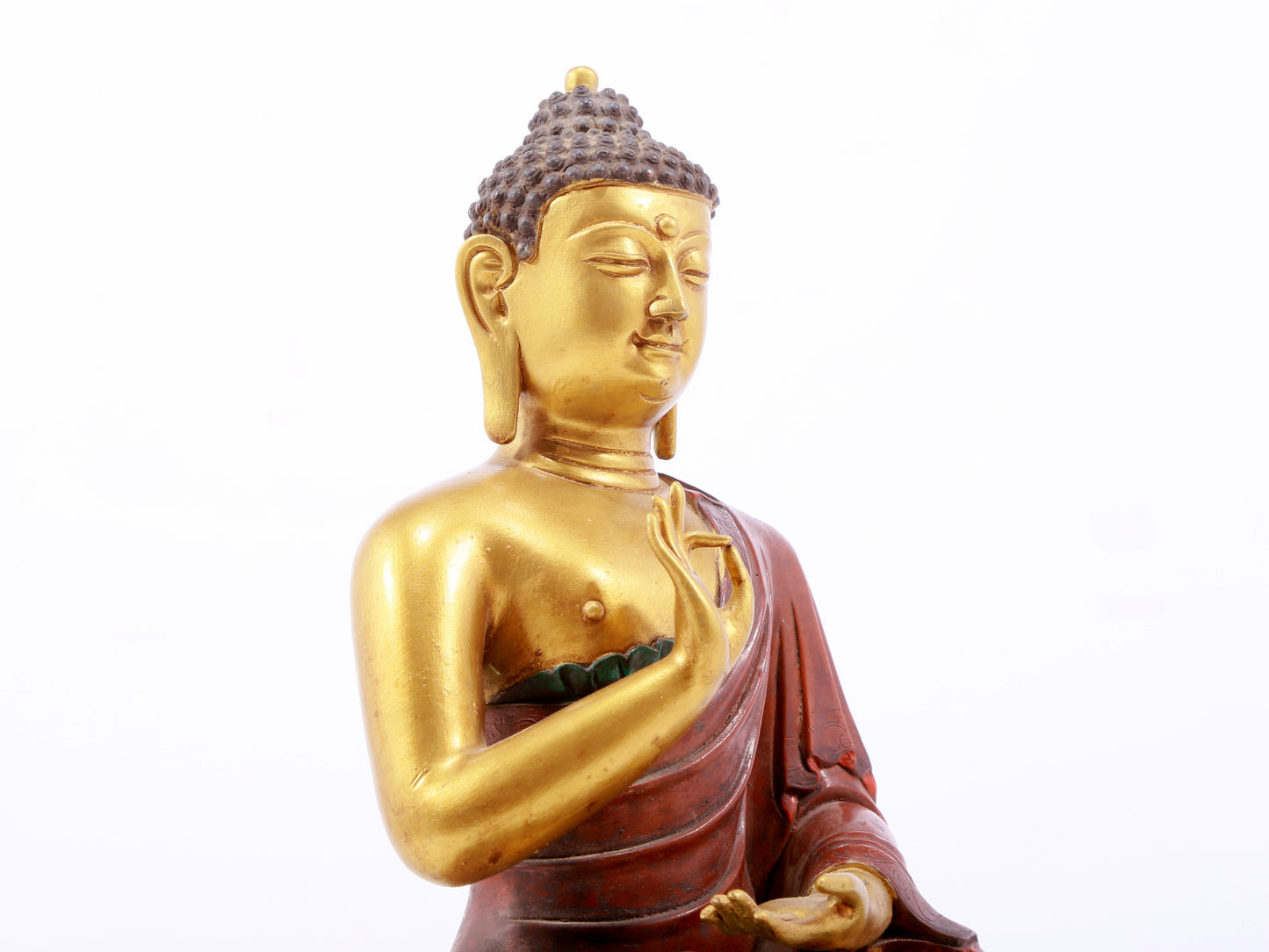 A serene gilt bronze statue of Gautama Buddha