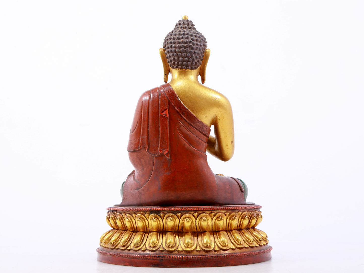 A serene gilt bronze statue of Gautama Buddha