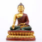 A serene gilt bronze statue of Gautama Buddha