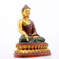 A serene gilt bronze statue of Gautama Buddha