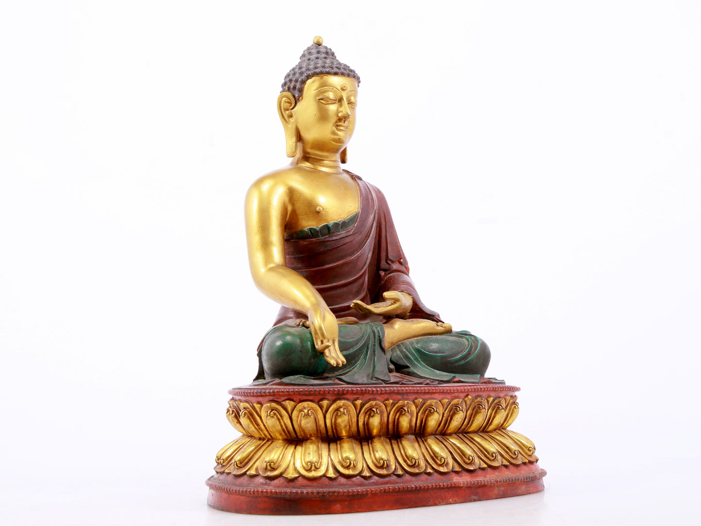 A serene gilt bronze statue of Gautama Buddha