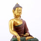 A serene gilt bronze statue of Gautama Buddha