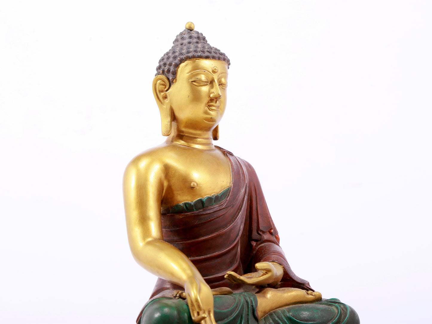 A serene gilt bronze statue of Gautama Buddha