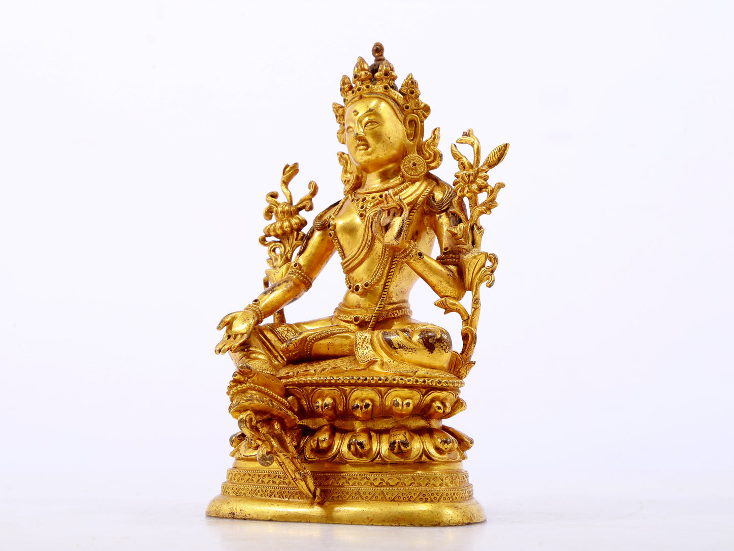 A serene gilt bronze green Tara statue