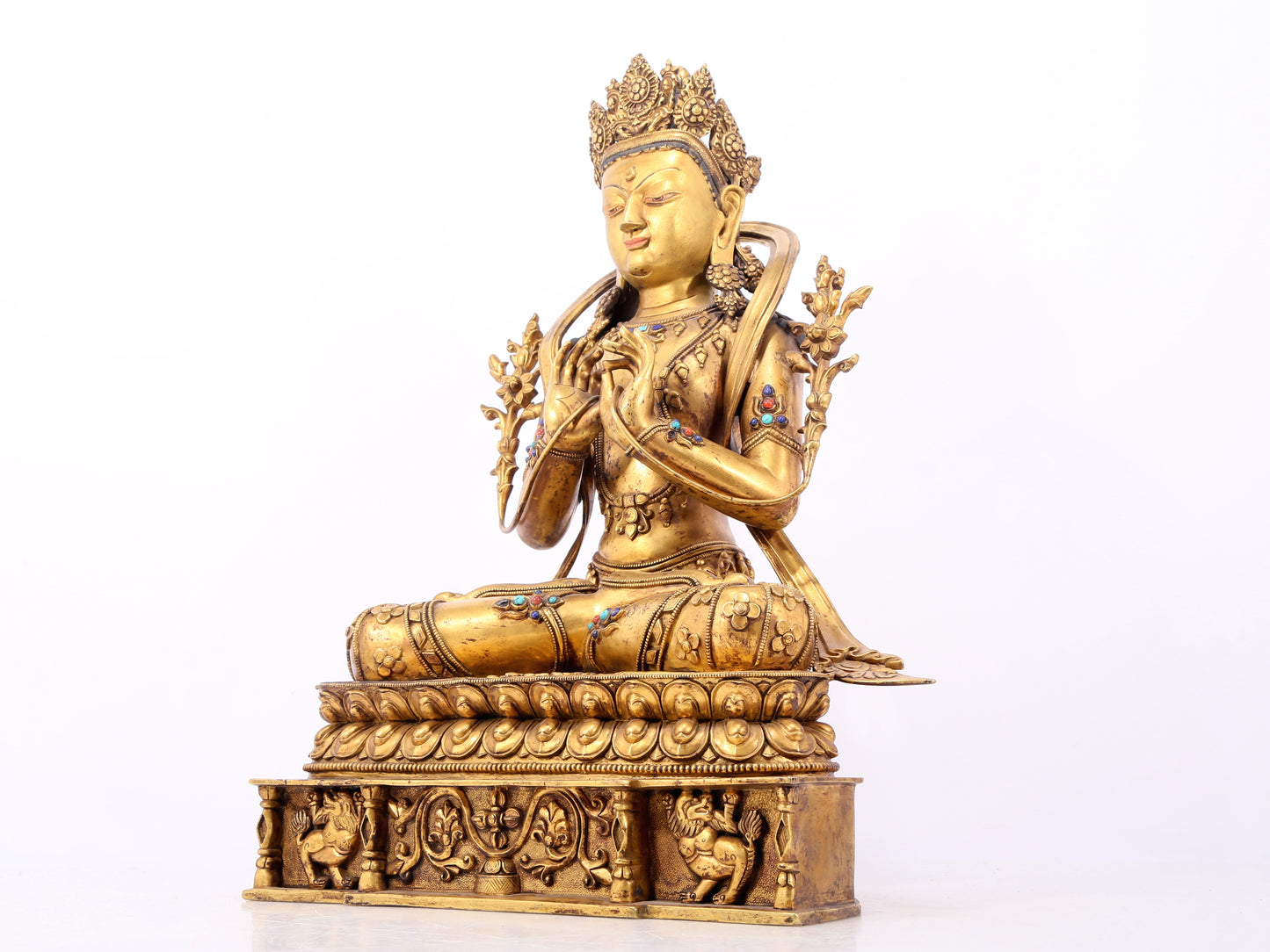 A serene gilt bronze statue of Bodhisattva inlaid with hundreds of treasures