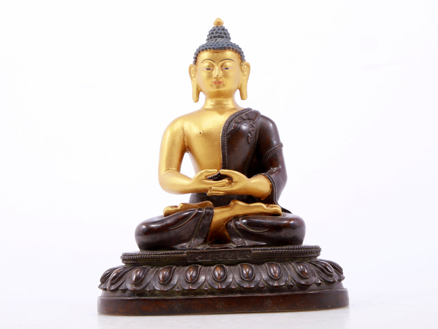 A serene gilt bronze statue of Gautama Buddha