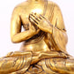 A serene gilt bronze statue of Gautama Buddha