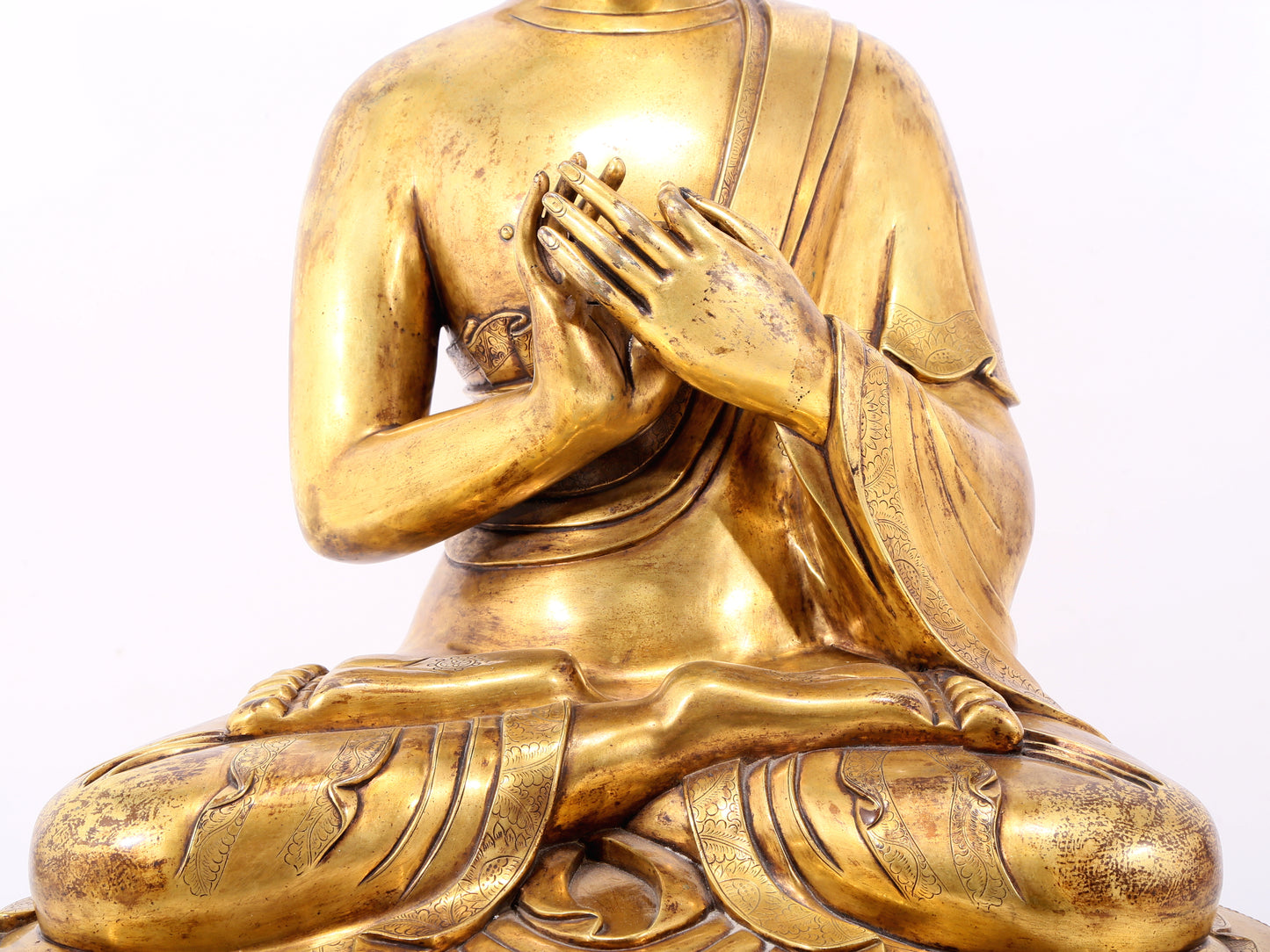 A serene gilt bronze statue of Gautama Buddha