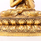 A serene gilt bronze statue of Gautama Buddha