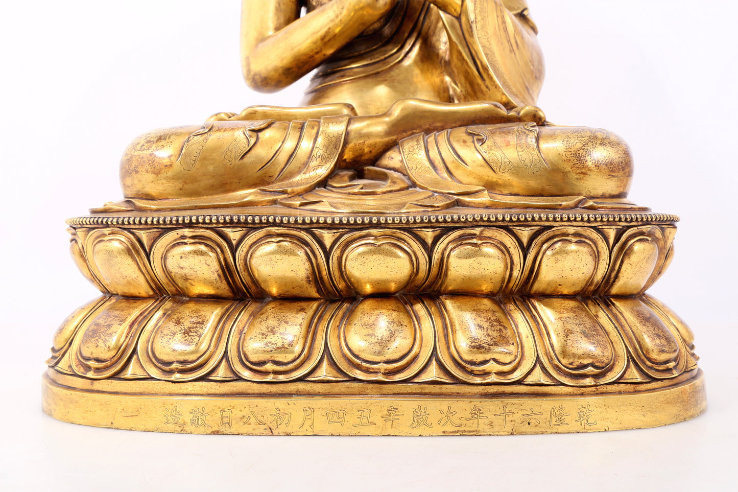 A serene gilt bronze statue of Gautama Buddha