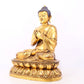 A serene gilt bronze statue of Gautama Buddha