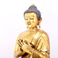 A serene gilt bronze statue of Gautama Buddha