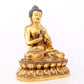 A serene gilt bronze statue of Gautama Buddha