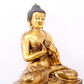 A serene gilt bronze statue of Gautama Buddha