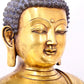 A serene gilt bronze statue of Gautama Buddha