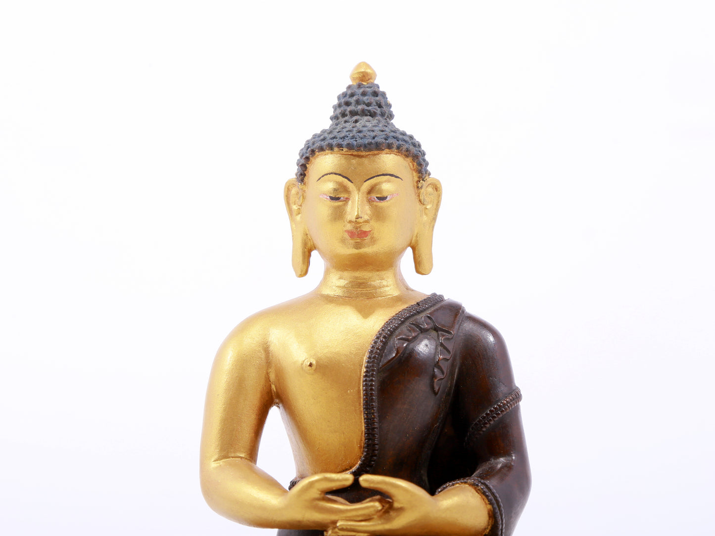 A serene gilt bronze statue of Gautama Buddha