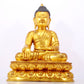 A serene gilt bronze statue of Gautama Buddha