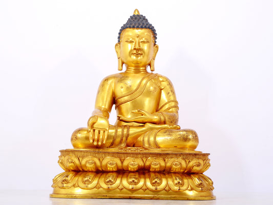 A serene gilt bronze statue of Gautama Buddha