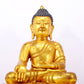 A serene gilt bronze statue of Gautama Buddha