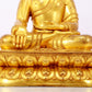 A serene gilt bronze statue of Gautama Buddha