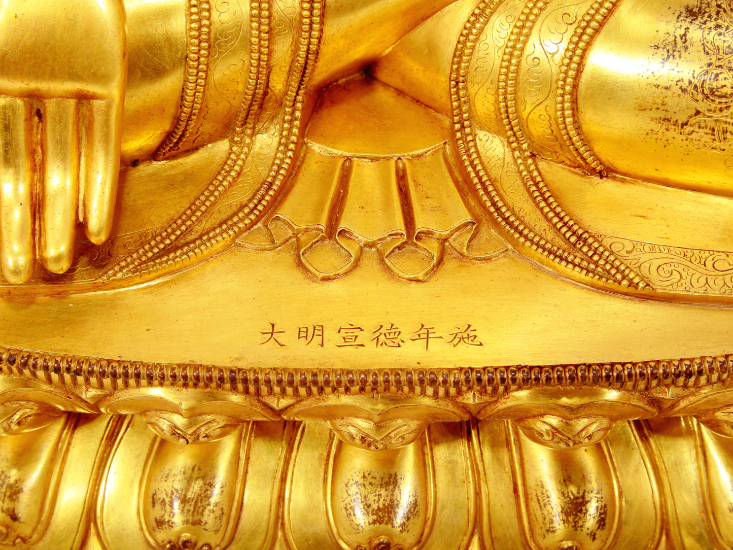 A serene gilt bronze statue of Gautama Buddha