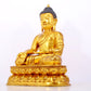 A serene gilt bronze statue of Gautama Buddha