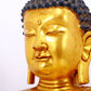 A serene gilt bronze statue of Gautama Buddha