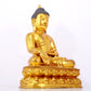 A serene gilt bronze statue of Gautama Buddha