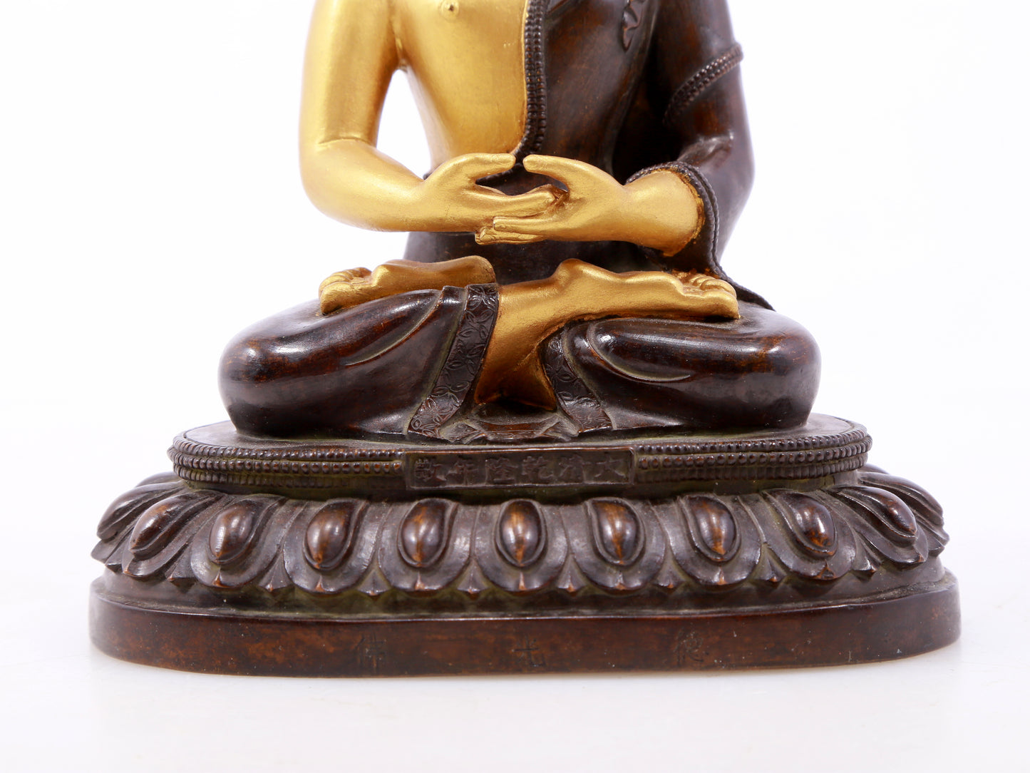 A serene gilt bronze statue of Gautama Buddha