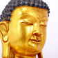 A serene gilt bronze statue of Gautama Buddha