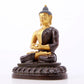 A serene gilt bronze statue of Gautama Buddha